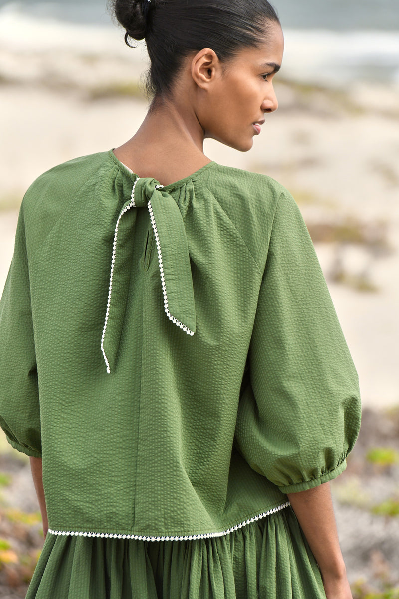 Wiggy Kit | Tie Back Top (Green Seersucker) | Model wearing green blouse and green skirt