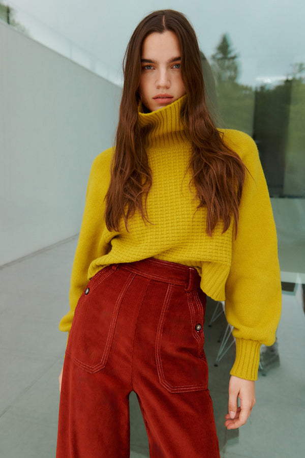 Wiggy Kit | The Cord Jean in Red | Model Wearing The Corn Jean in Red with Yellow Jumper