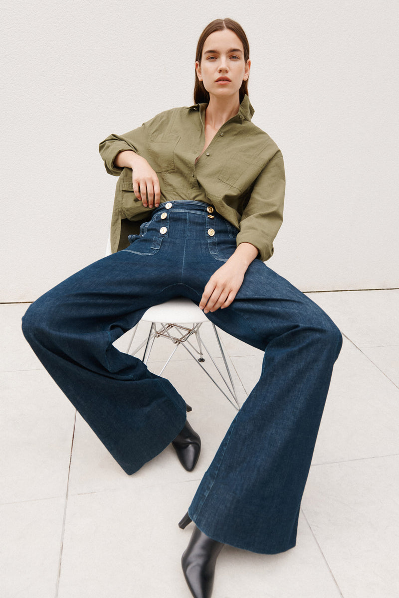 Wiggy Kit | The Sailor Jean in Indigo | Model Wearing Jeans and Green Top