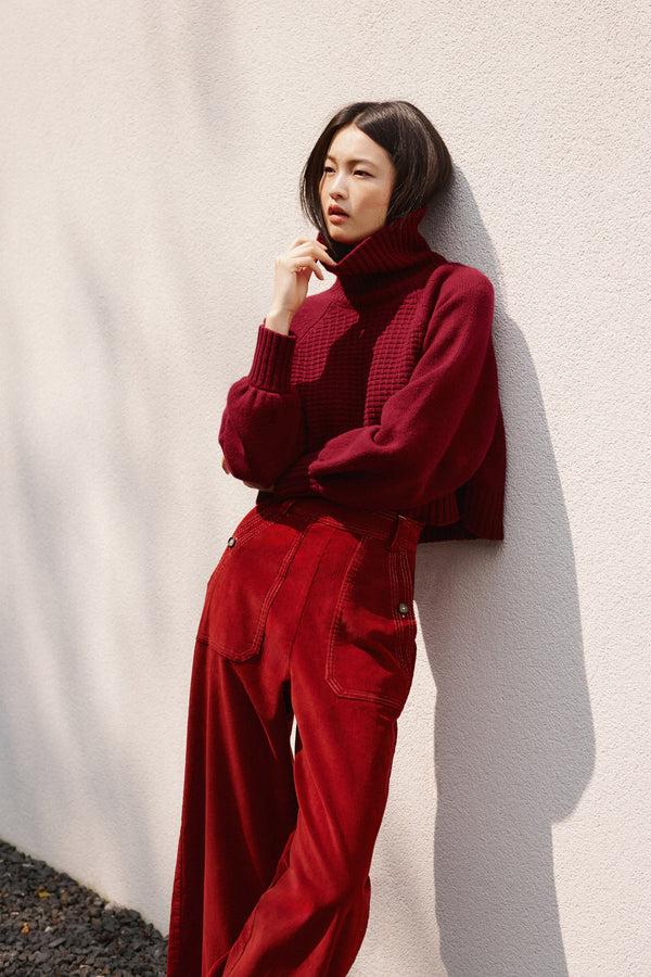 Wiggy Kit | Waffle Turtleneck in Dark Red | Model Wearing Dark Red Jumper and Red Jeans