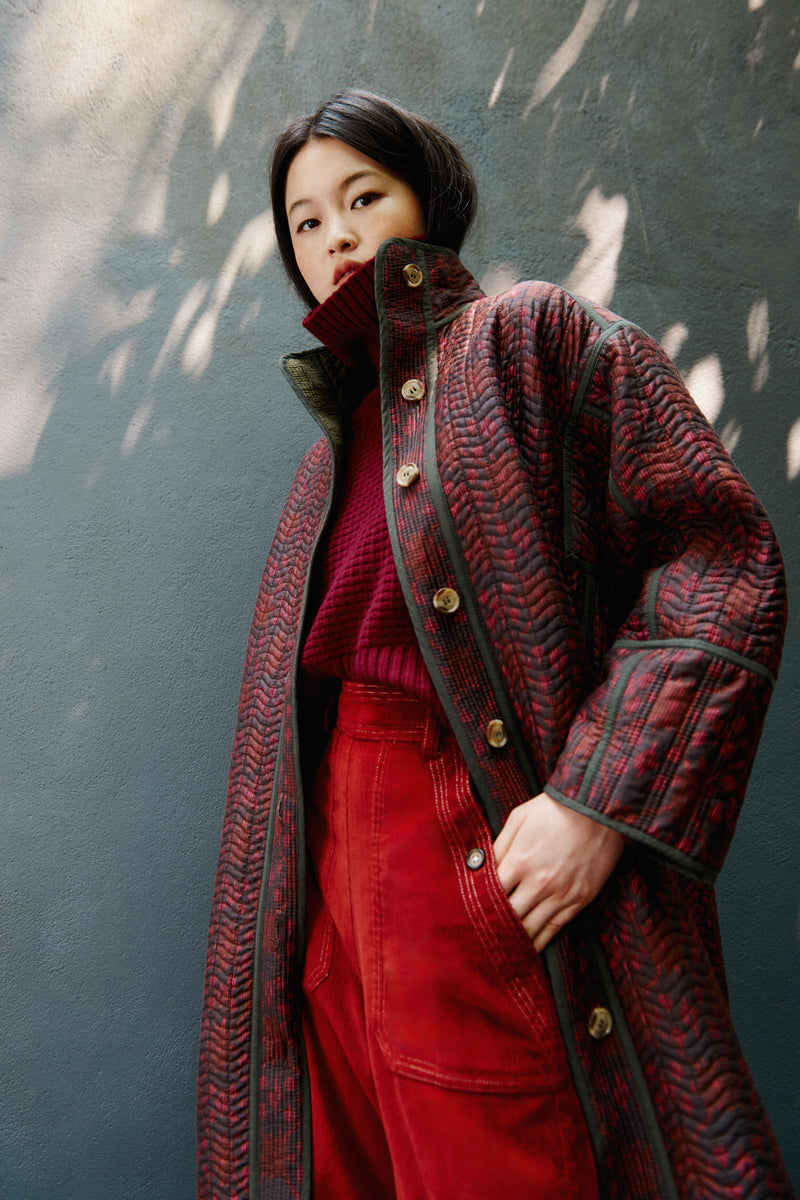 Wiggy Kit | Reversible Quilted Coat | Model Wearing Reversible Quilted Coat in Pink and Black Print