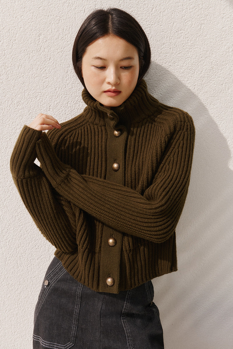 Wiggy Kit | Ribbed High Neck Jacket in Green | Model Wearing Ribbed High Neck Jacket with Jeans