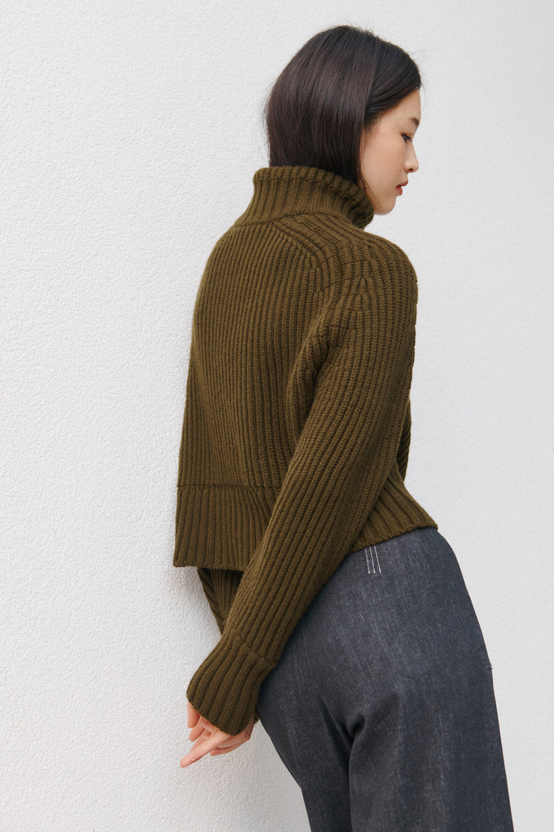 Wiggy Kit | Ribbed High Neck Jacket in Green | Model Wearing Ribbed High Neck Jacket with Jeans