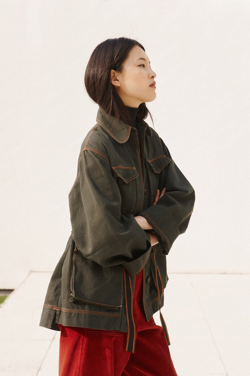 Wiggy Kit | The Milano Jacket in Green | Model Wearing Green Jacket with Red Jeans