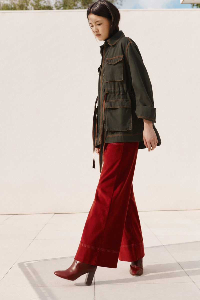 Wiggy Kit | The Milano Jacket in Green | Model Wearing Green Jacket with Red Jeans