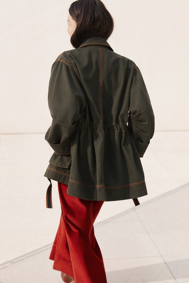 Wiggy Kit | The Milano Jacket in Green | Model Wearing Green Jacket with Red Jeans