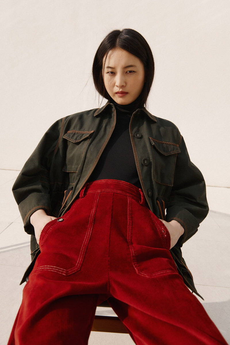 Wiggy Kit | The Milano Jacket in Green | Model Wearing Green Jacket with Red Jeans