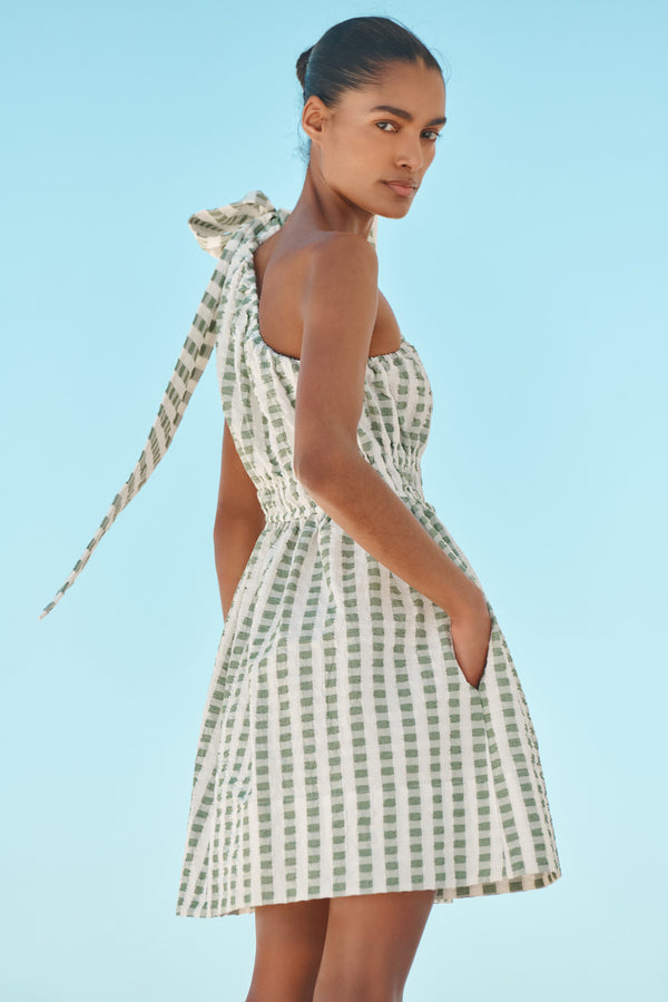 Wiggy Kit | The Minnie Mini | Model wearing mini one shoulder green gingham dress