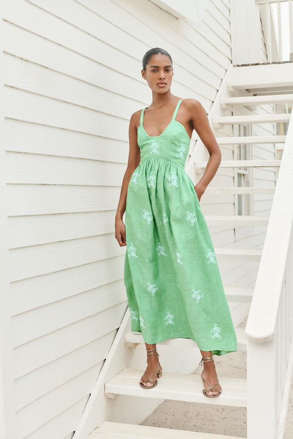 Wiggy Kit | The Petra Dress | Model wearing green maxi dress with blue embroidery