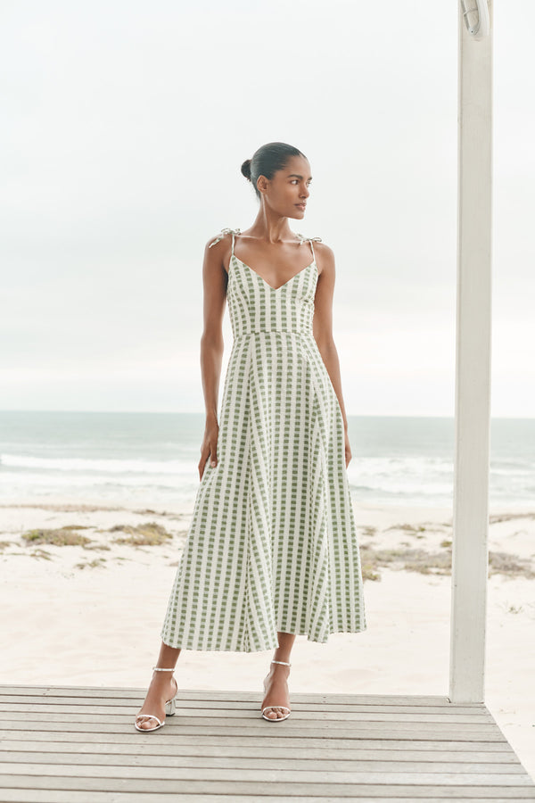 Wiggy Kit | Ekberg Dress (Green Gingham) | Model wearing maxi gingham dress with beach in background