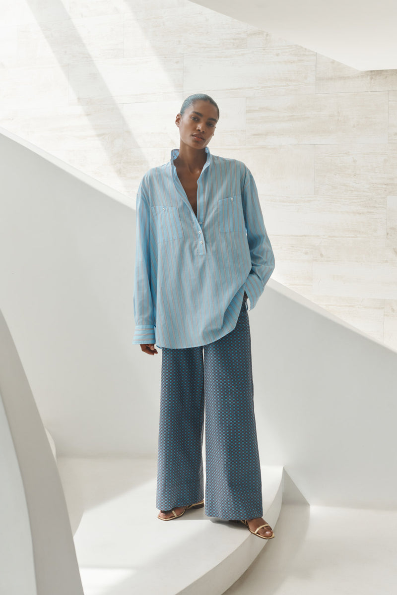 Wiggy Kit | The Penfold Shirt | Model wearing light blue striped shirt and blue high waist trousers