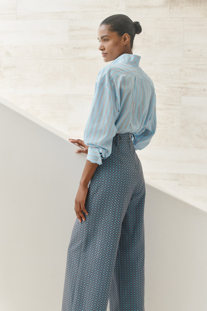Wiggy Kit | The Penfold Shirt | Model wearing light blue striped shirt and blue high waist trousers