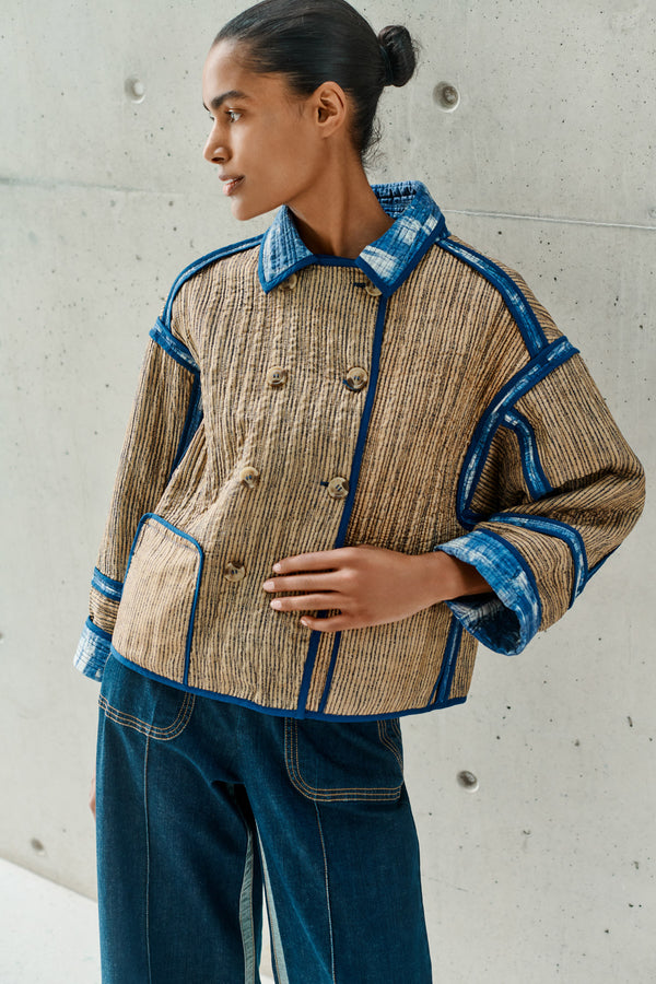 Wiggy Kit | Quilted Double-Breasted Jacket | Model wearing reversible beige patterned jacket