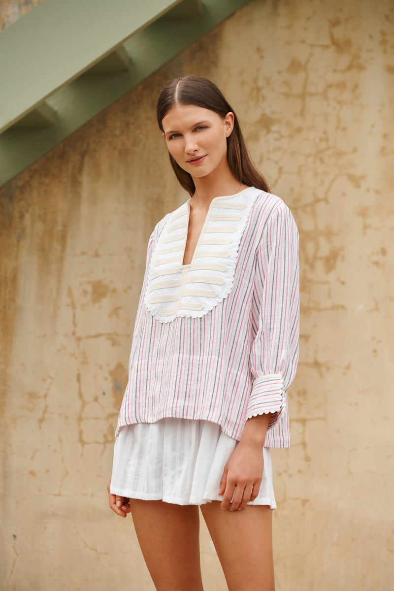 Wiggy Kit | Bib Shirt | Model wearing shirt in pink and blue stripe print