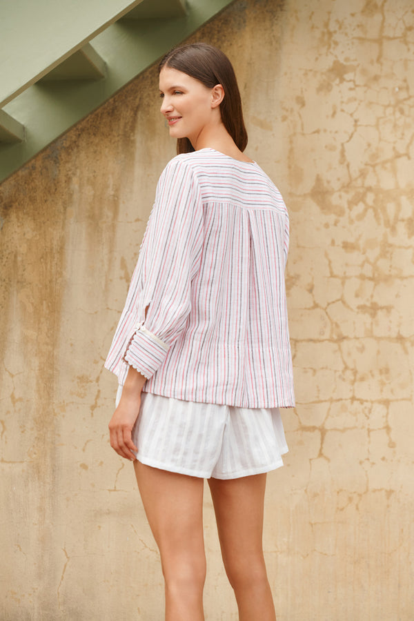 Wiggy Kit | Bib Shirt | Model wearing shirt in pink and blue stripe print