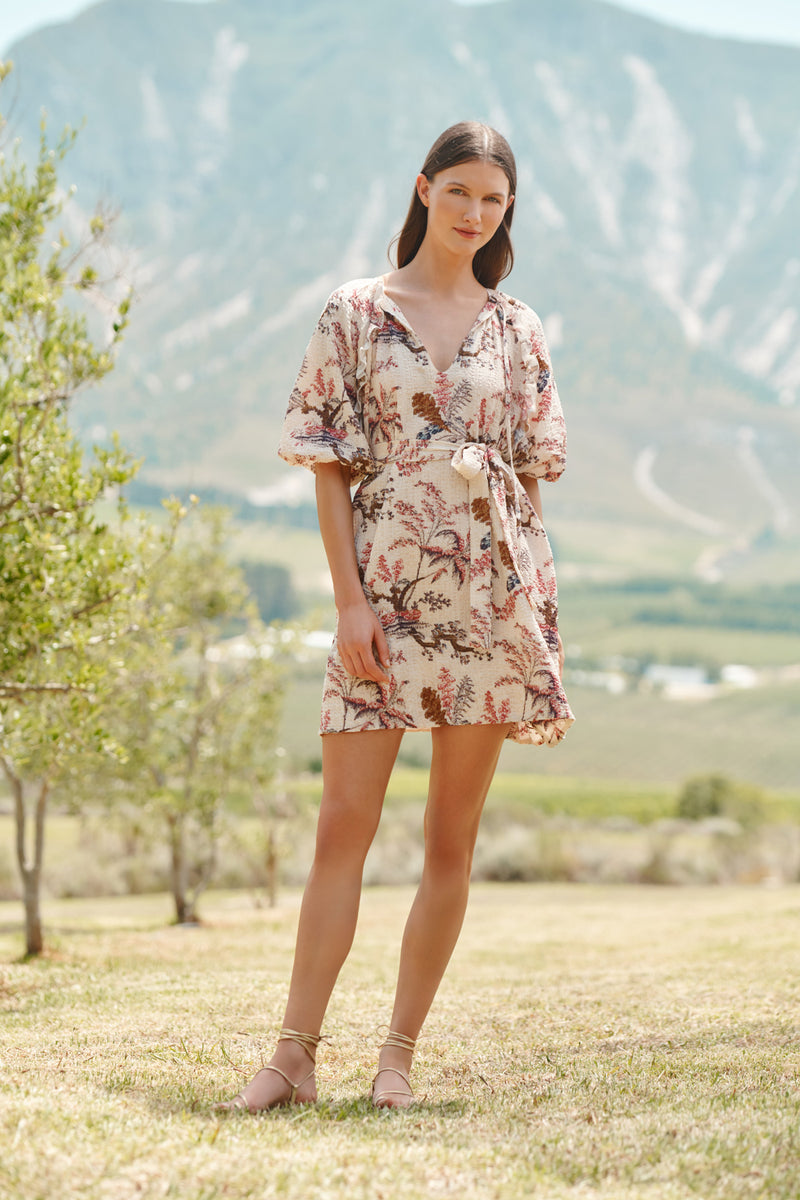 Wiggy Kit | Bubble Dress Palm Print | Model wearing floral patterned pink and cream dress