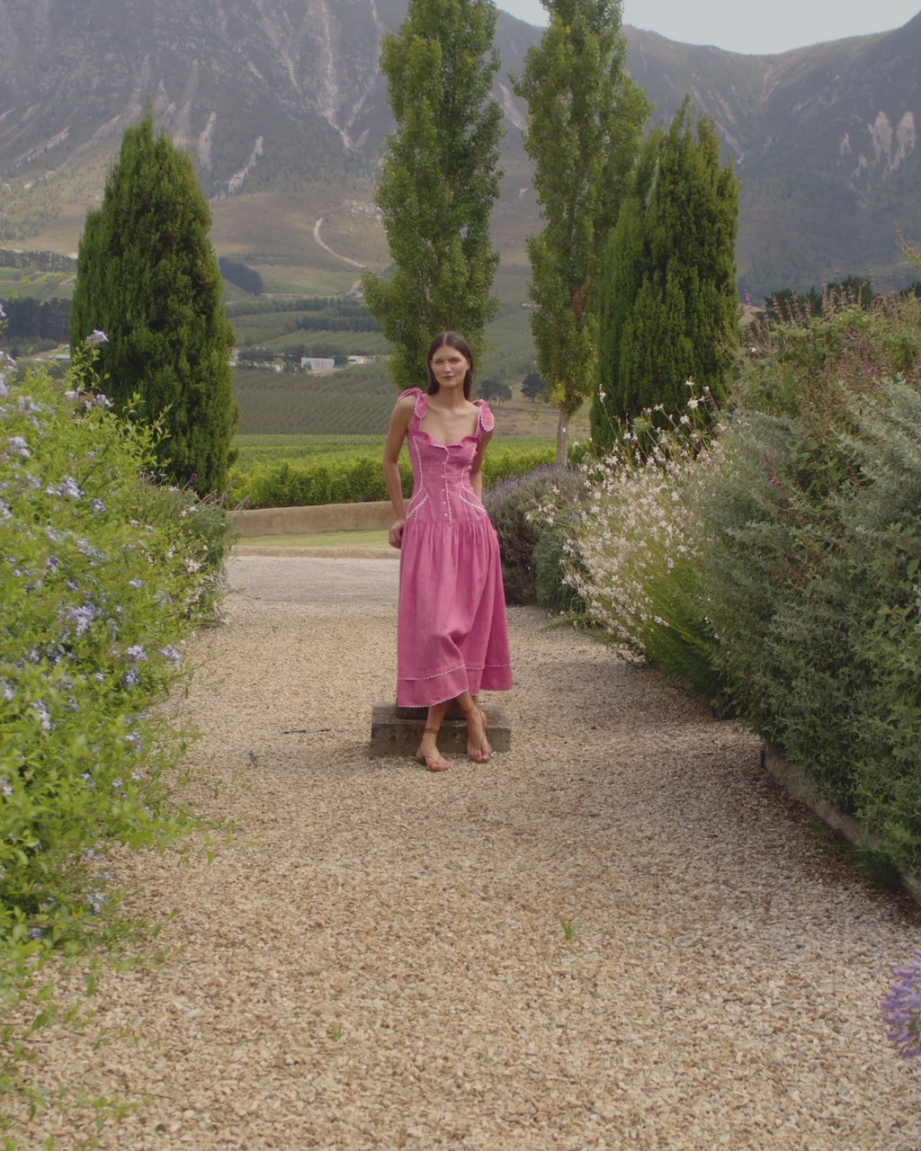 Wiggy Kit | Eden Dress (Pink) | Model wearing midi length pink dress with white trims