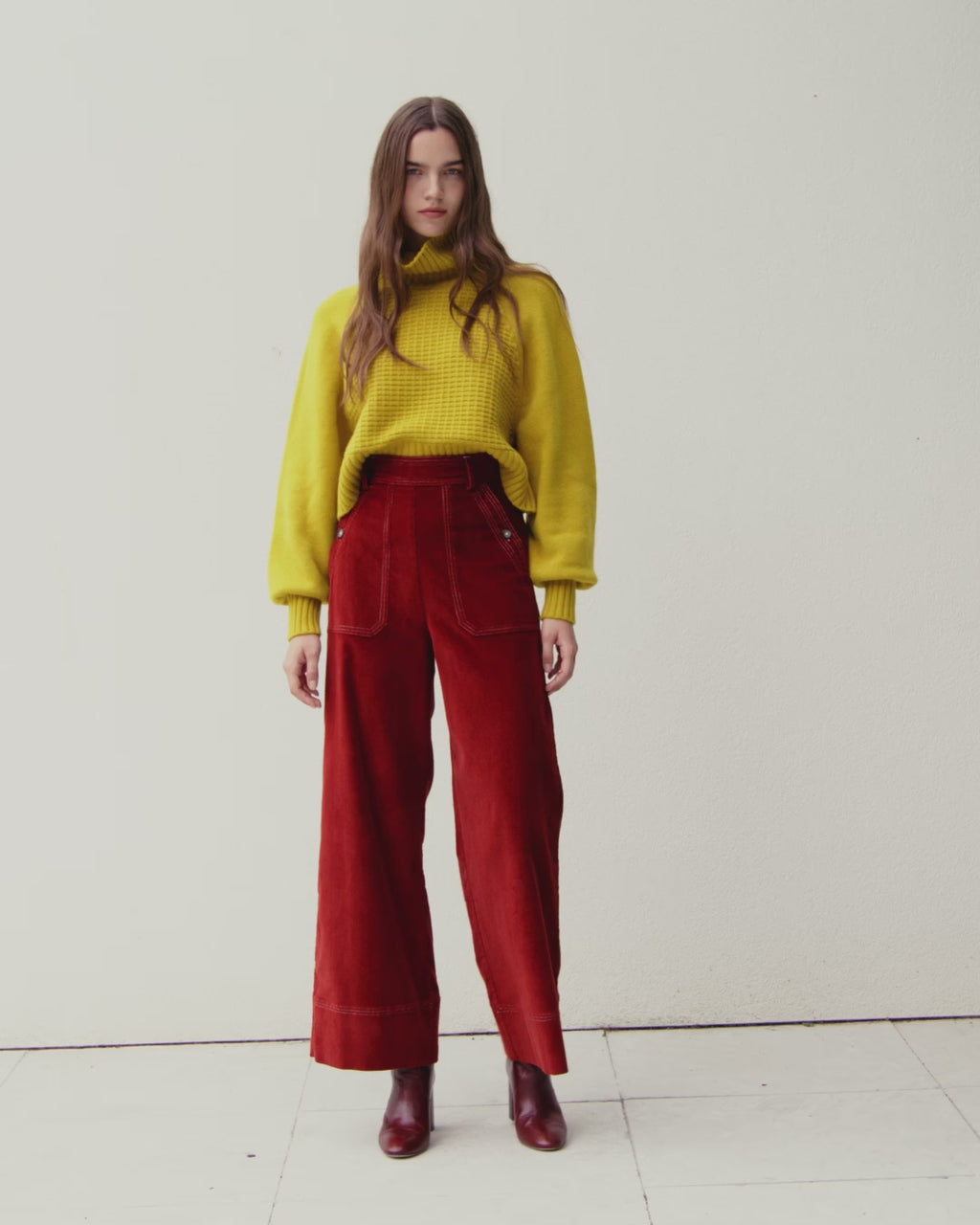Wiggy Kit | Waffle Turtleneck in Yellow | Video of Model Wearing Yellow Jumper and Red Jeans