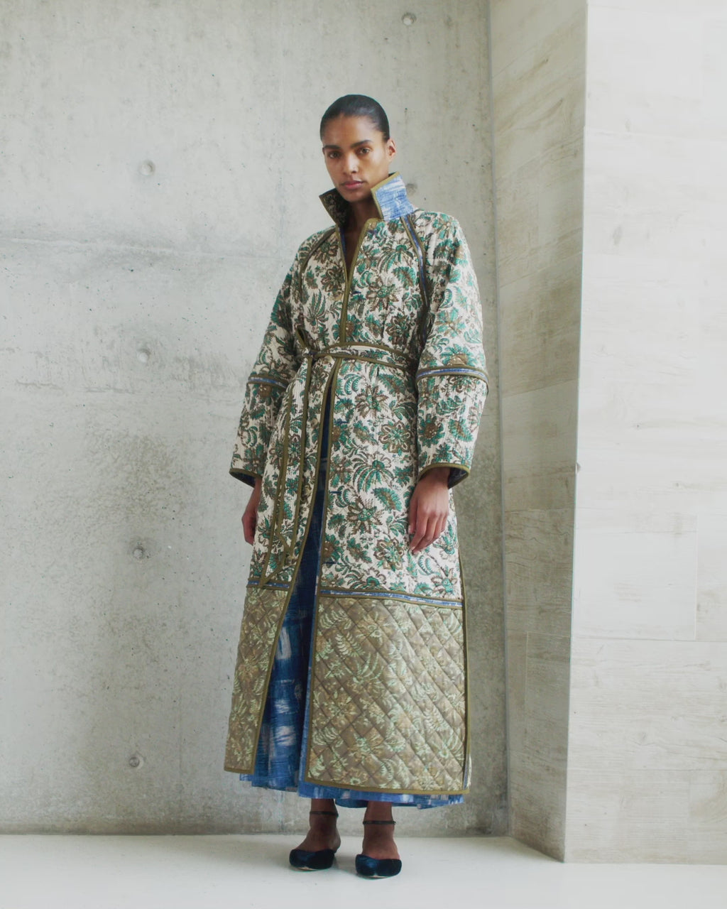 Wiggy Kit | Quilted Raglan Coat | Video of model wearing long floral reversible coat with blue dress underneath