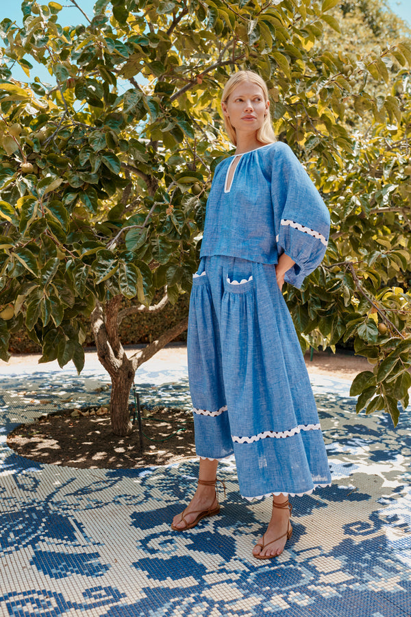 Wiggy Kit | Gaucho Top in Blue Linen | Lifestyle Image, Front of Top with Model by Tree