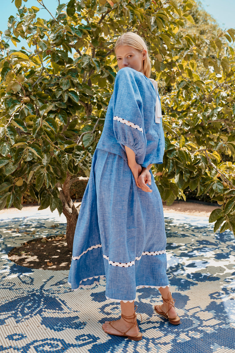 Wiggy Kit | Gaucho Top in Blue Linen | Lifestyle Image, Side of Top with Model by Tree