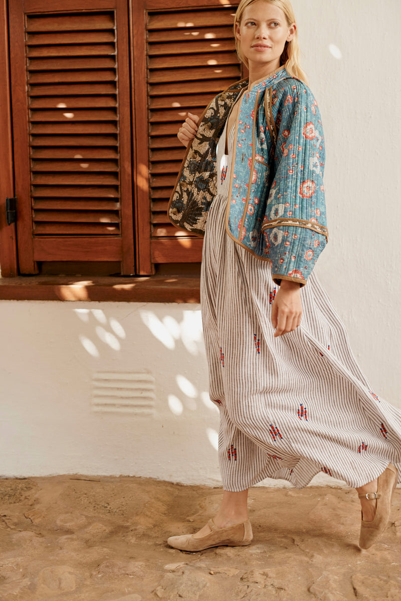 Wiggy Kit | Reversible Quilt Jacket | Lifestyle Image, Side of Jacket with Dress